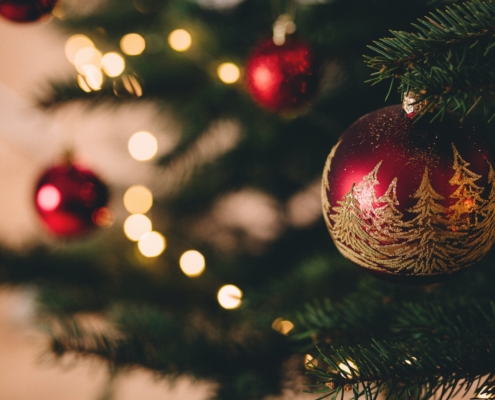shallow focus photography of red bauble on christmas tree